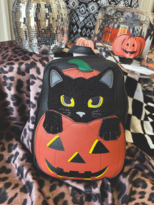 Black cat in pumpkin backpack