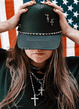 OUTCAST ANTHEM: Black piercing trucker hat
