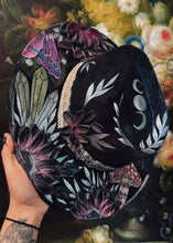 Black raven with beaded hat band