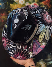 Black raven with beaded hat band