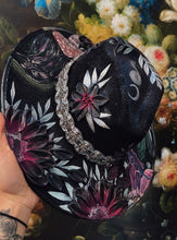 Black raven with beaded hat band