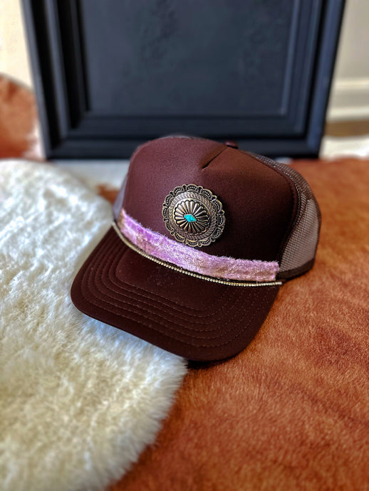 One of one: brown with pink concho trucker hat
