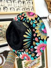 Black blue and pink with gold hat